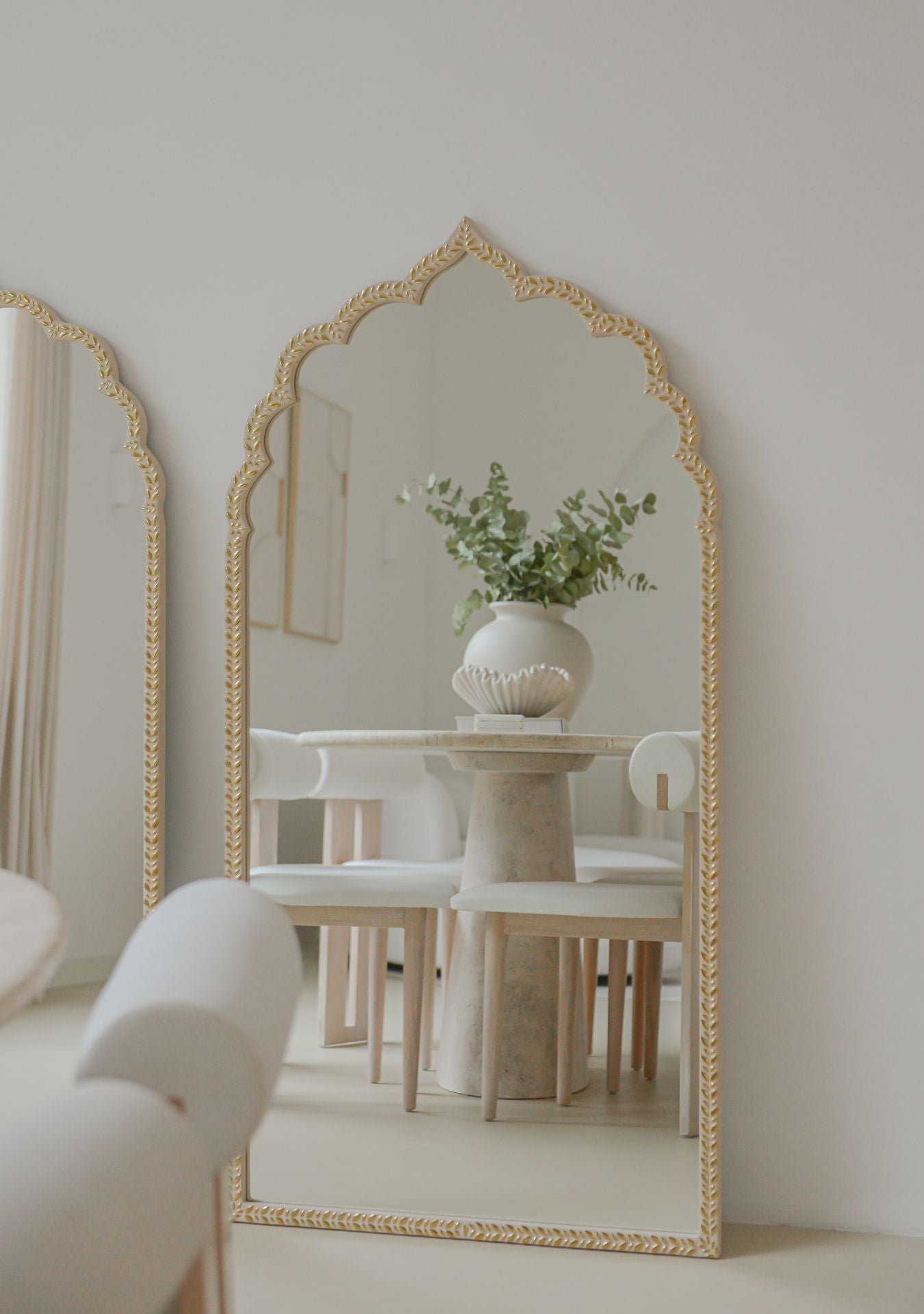 Mirror Clarity Gold styled in a soft, serene interior with warm natural light.