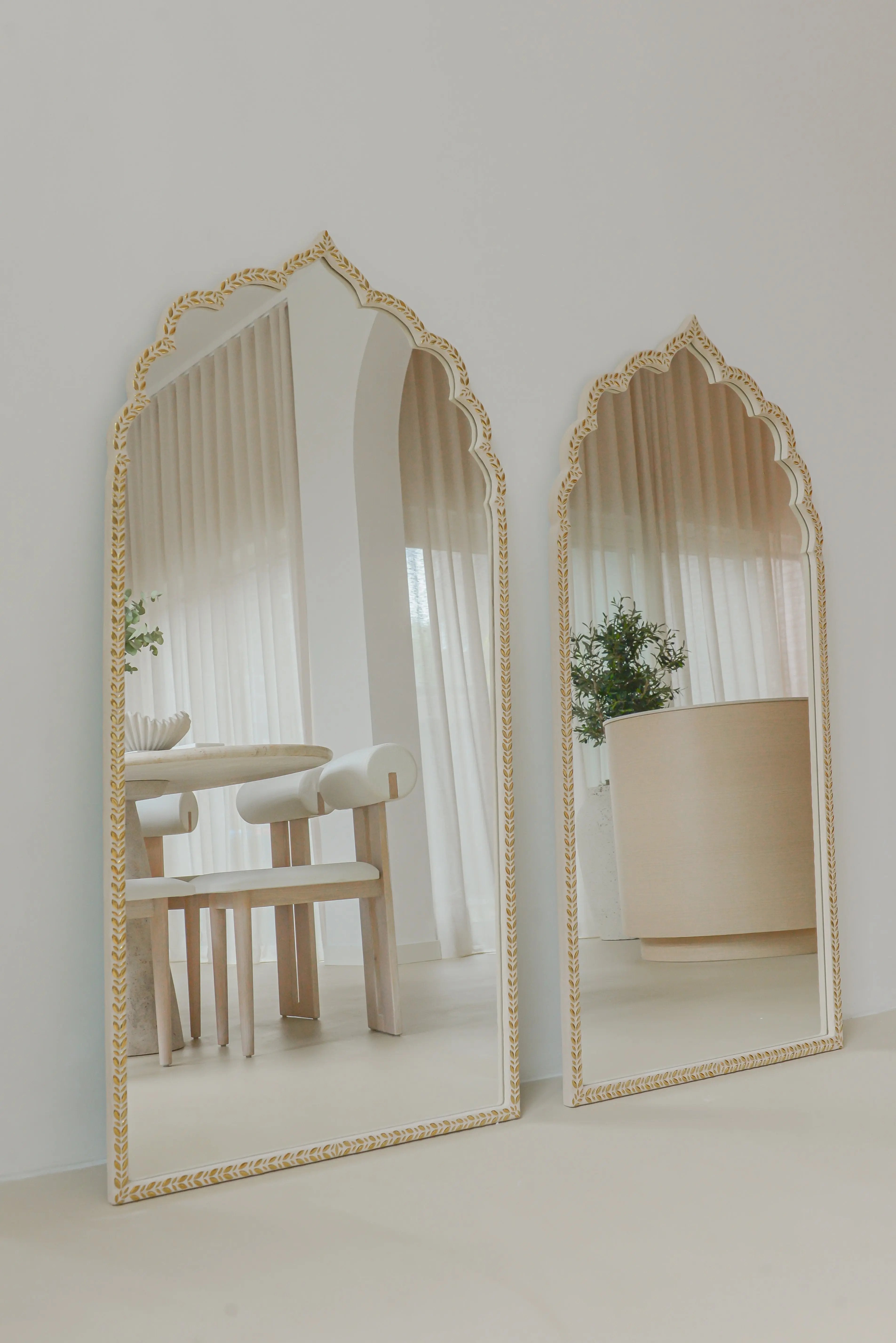 Elegant arched designer mirror made of gold ceramic and grout, blending art and reflection.