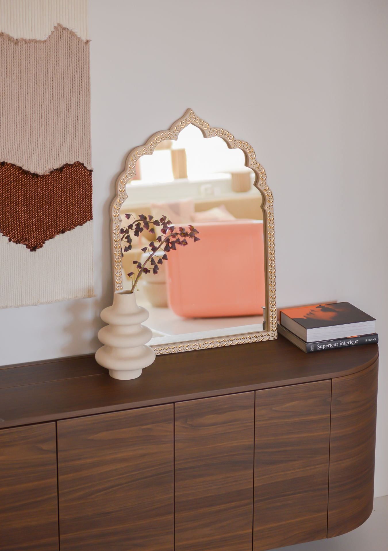 Handcrafted gold mosaic mirror with oriental arch shape on a wooden sideboard, styled in a calm interior – Pure Reflection.