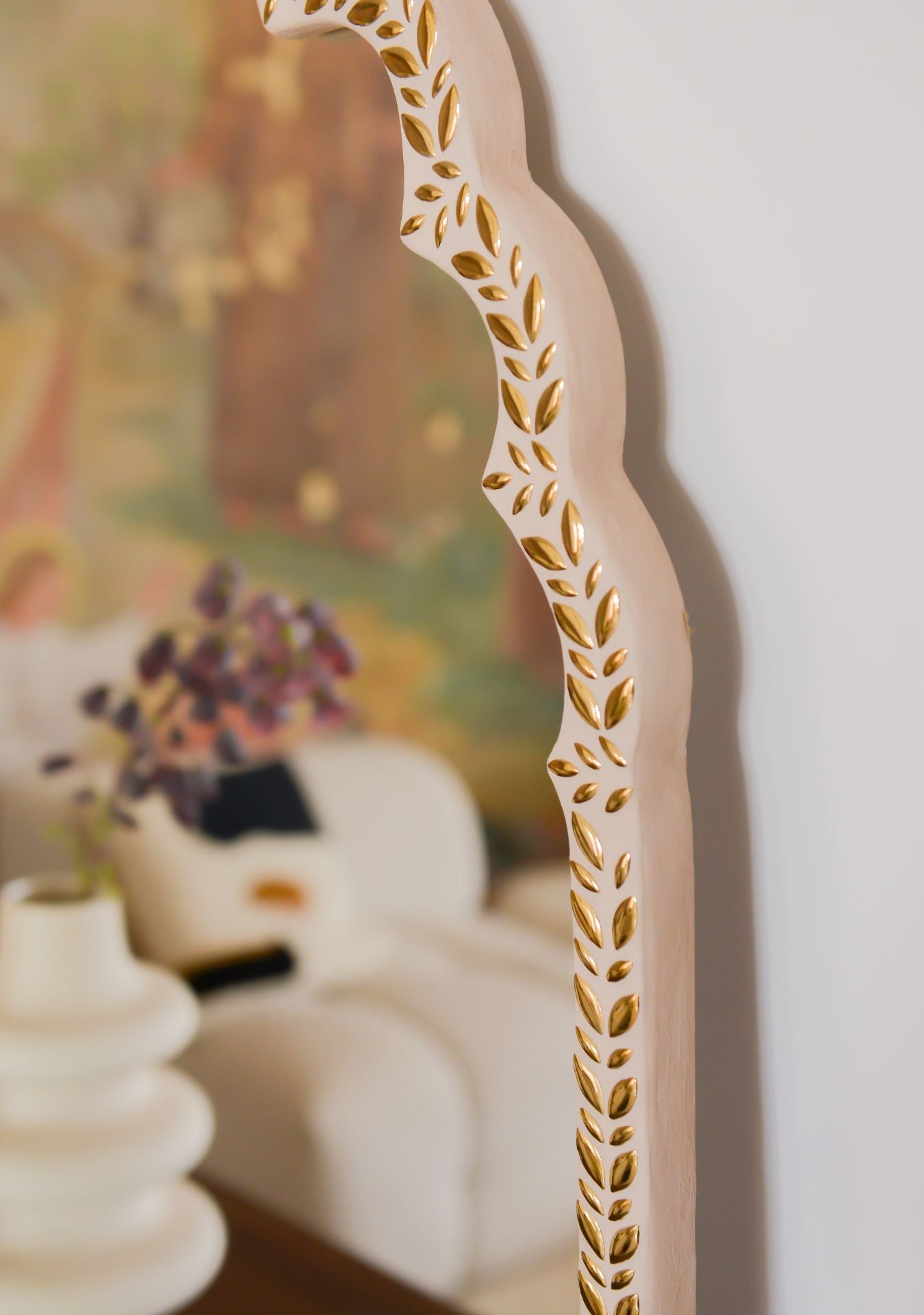 Detail of golden mosaic edge on a handcrafted oriental mirror, reflecting a serene interior – Pure Reflection.