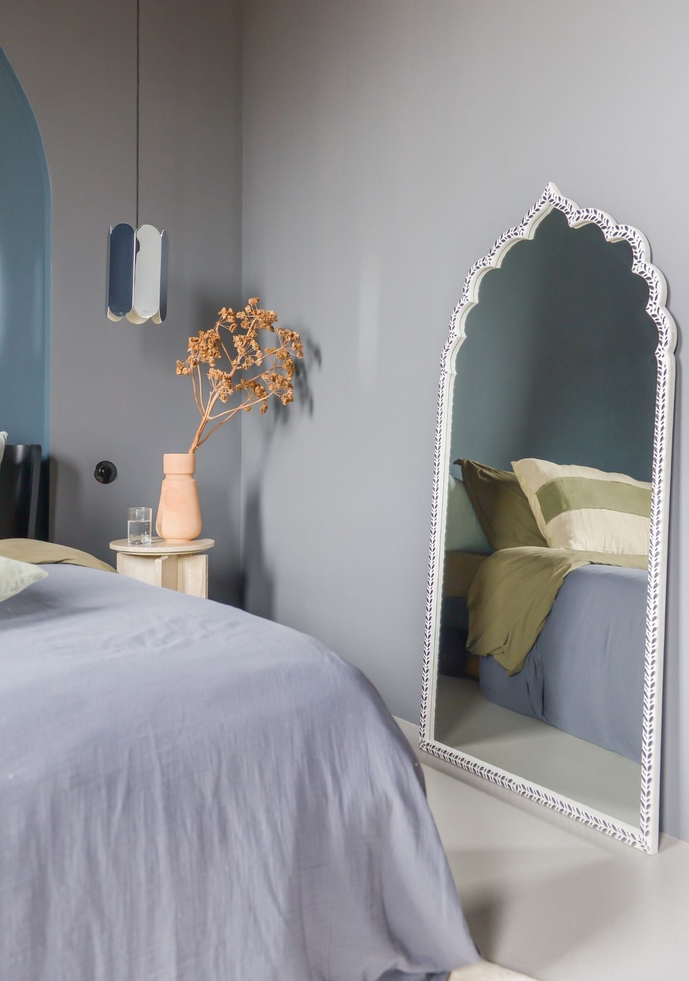 Handmade designer mirror with silver tones adding depth and sophistication to the space.
