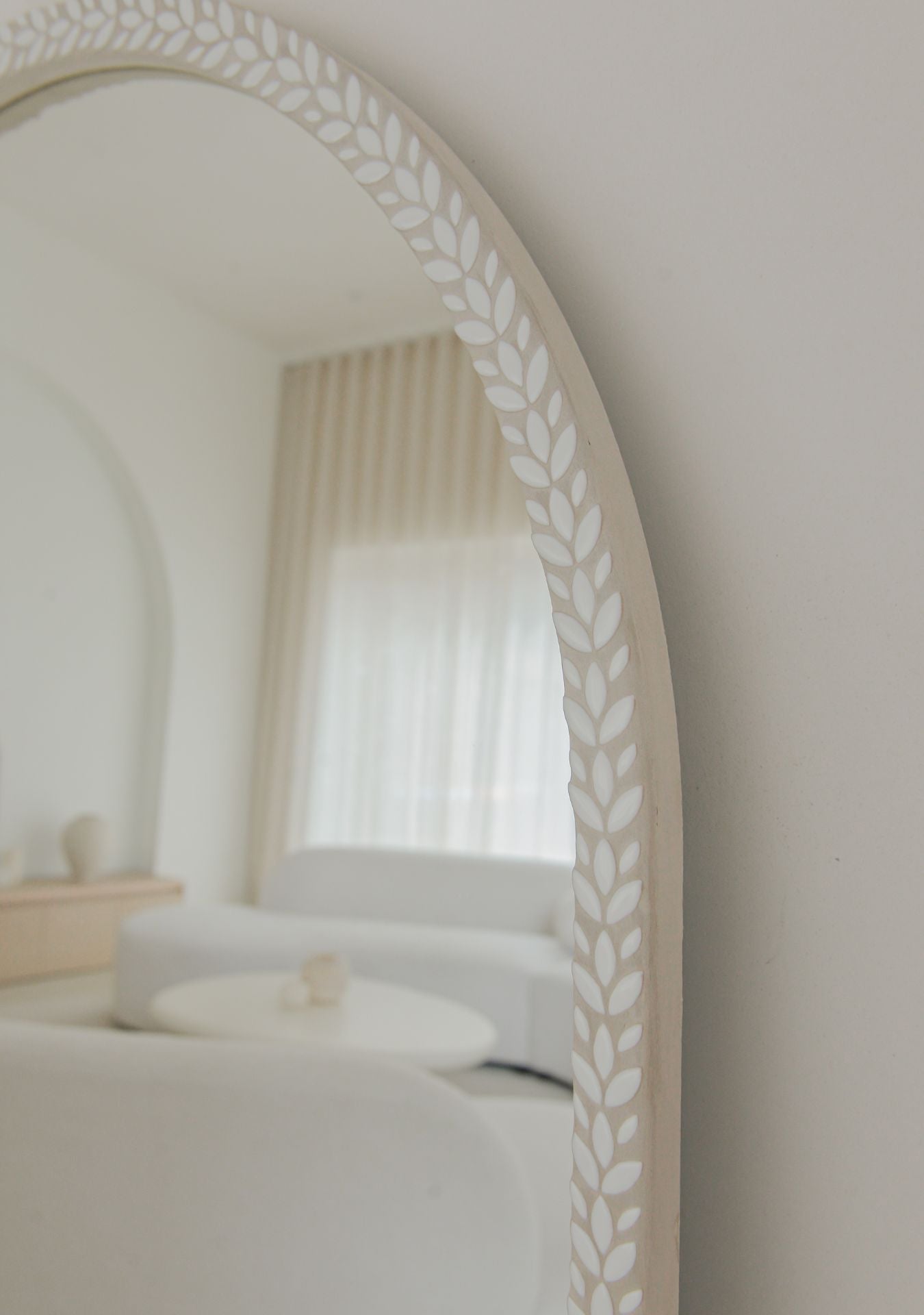 Elegant arched mosaic mirror with handmade ceramic details in pure white finish.