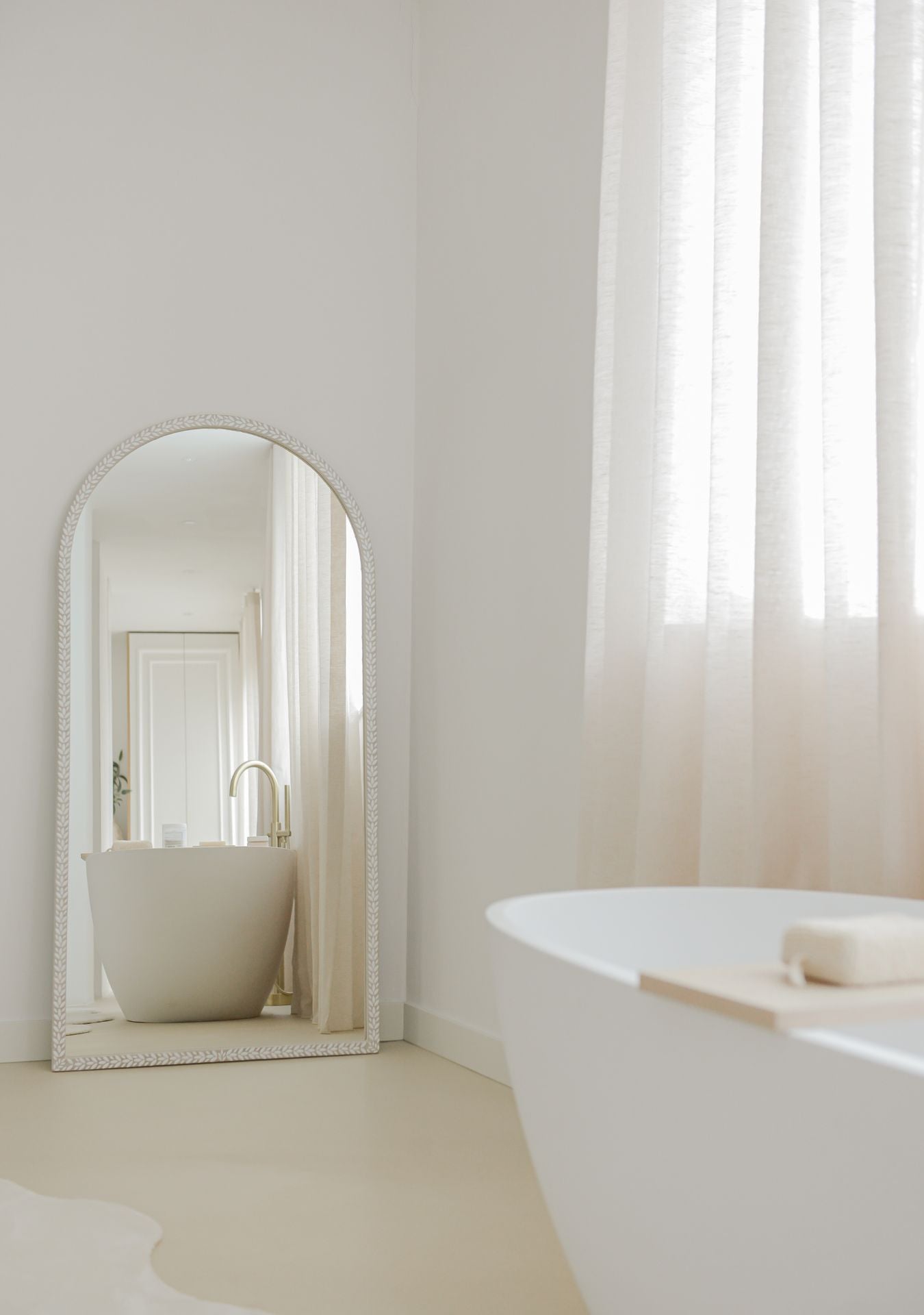 Minimal arched mirror in white tones, handcrafted for timeless and serene interiors.