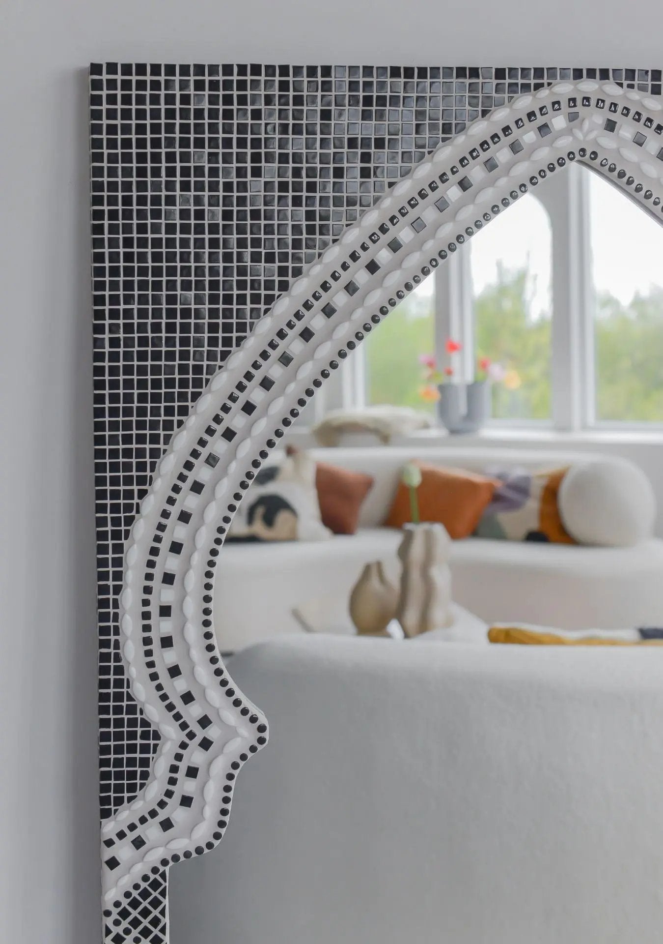Artisan-made black mosaic mirror reflecting calm and refined interior styling.