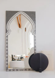 Handcrafted black mosaic mirror with arched designer shape and ceramic details.