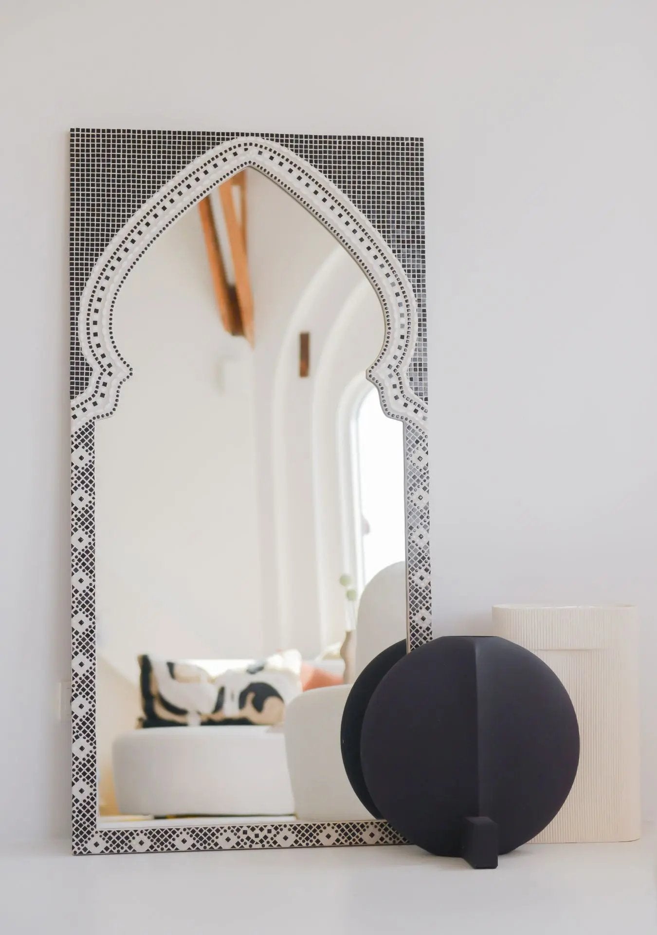 Handcrafted black mosaic mirror with arched designer shape and ceramic details.