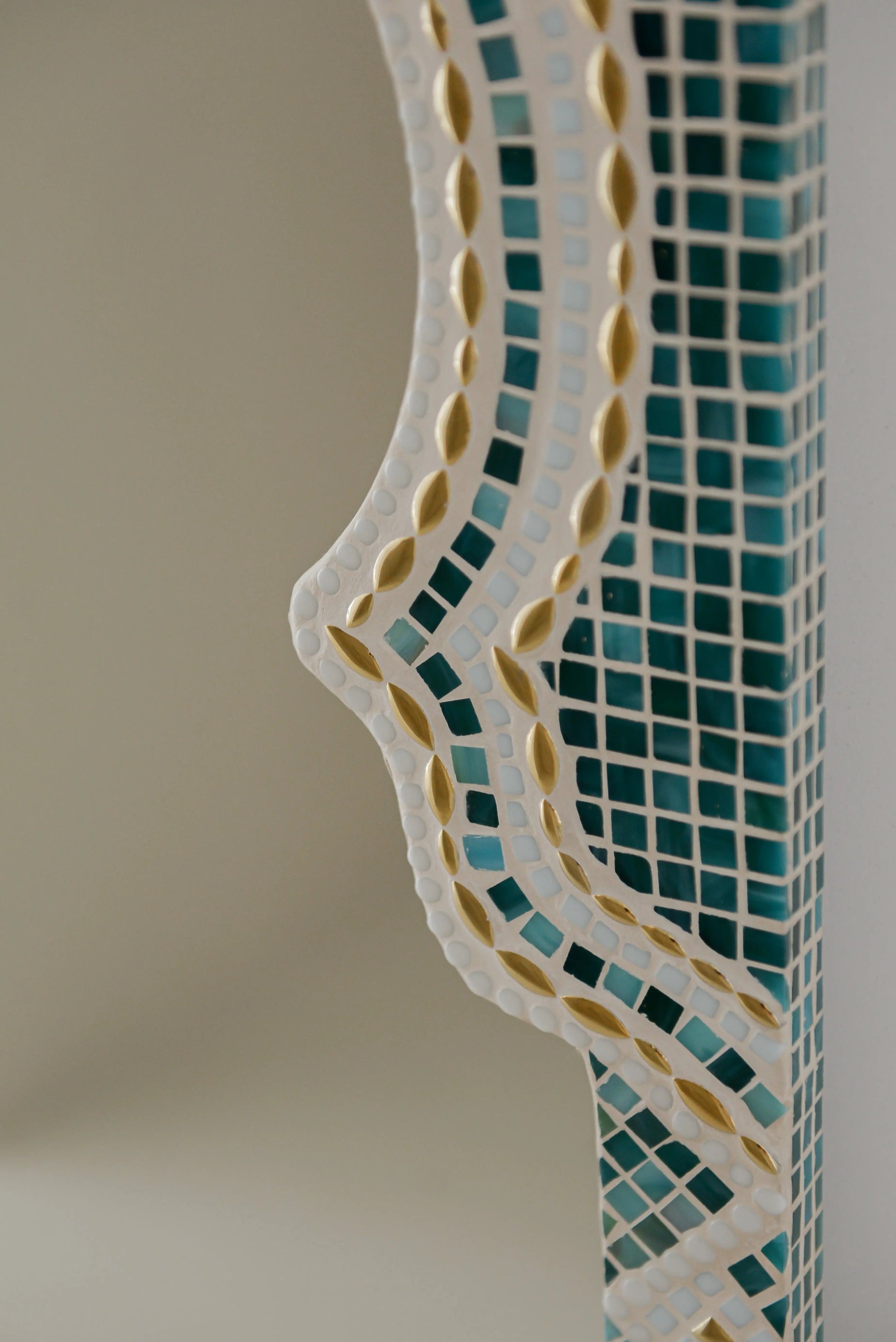 Textured mosaic pattern of Maraya Green mirror with green, gold, blue and white stones.