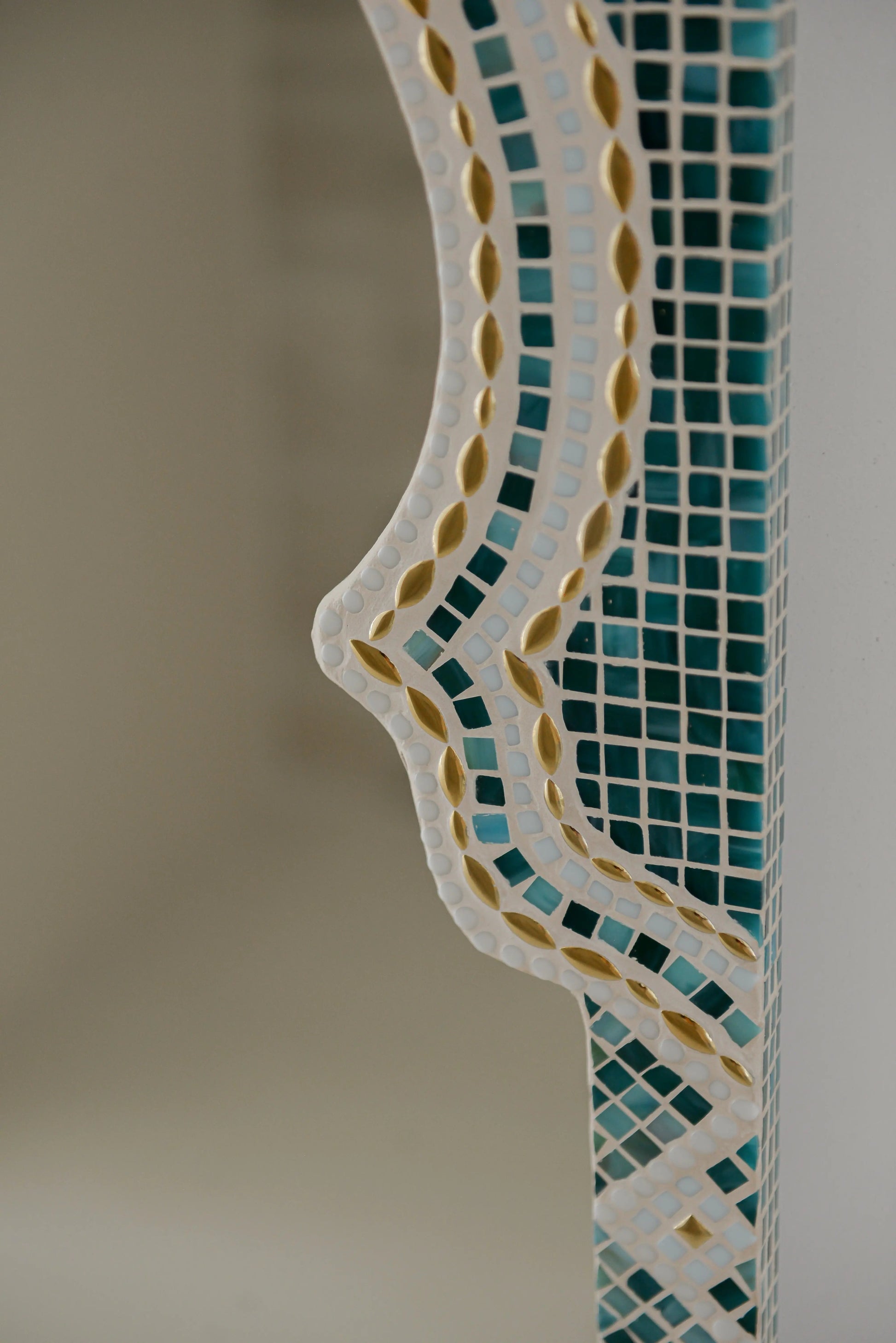 Textured mosaic pattern of Maraya Green mirror with green, gold, blue and white stones.