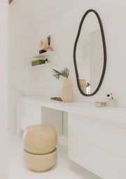 Handcrafted oval designer mirror made of glass, ceramic and grout in black finish.