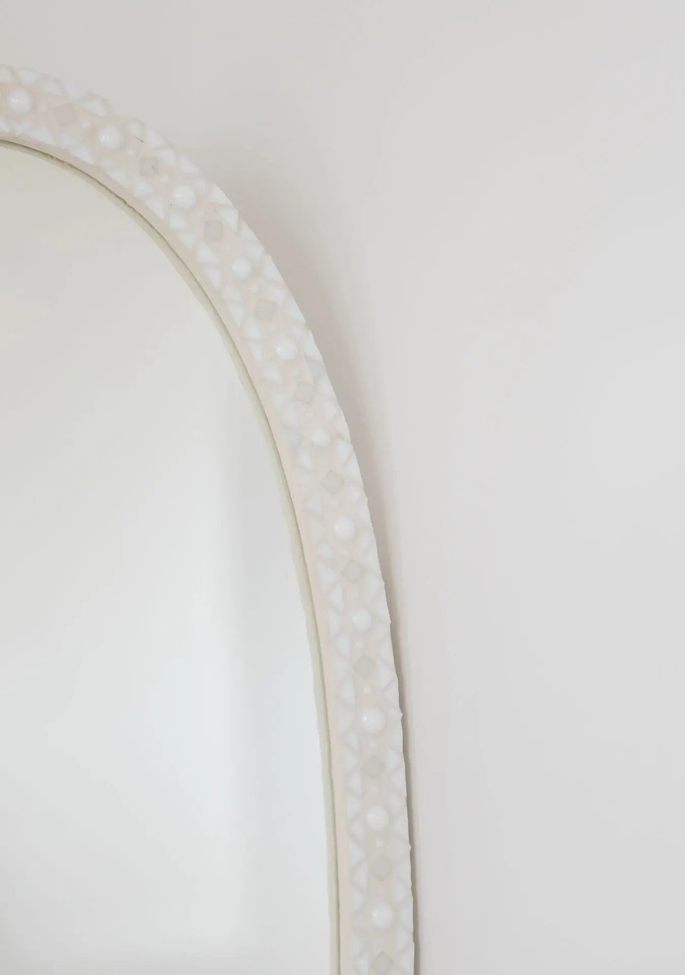 Close-up of mosaic craftsmanship and grout texture on the handmade Pure Reflection mirror.